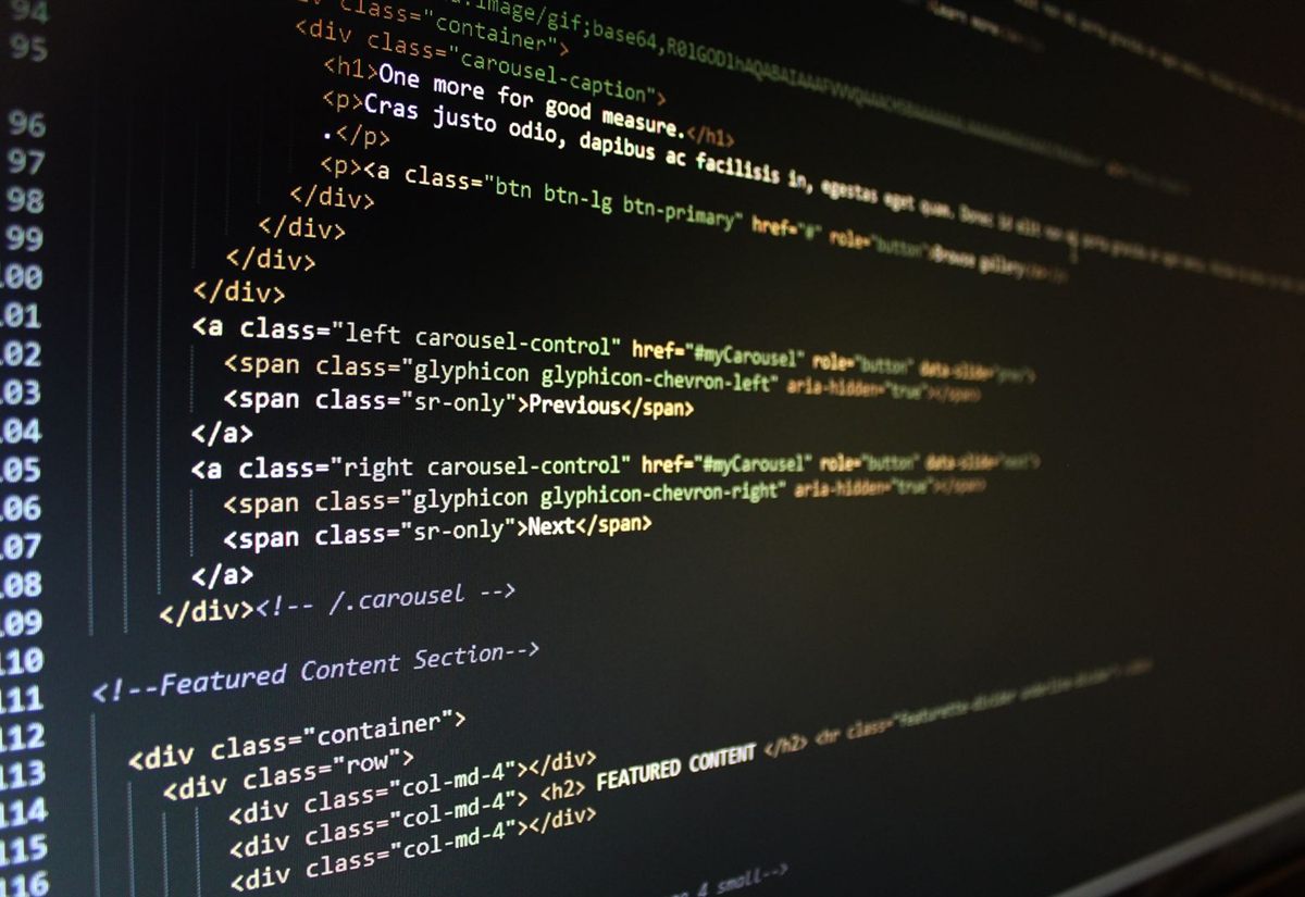 Close-up of hand-written HTML code on screen